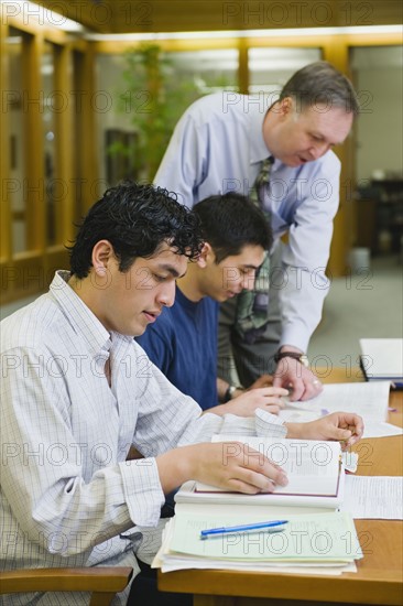 Professor giving instruction to college students.