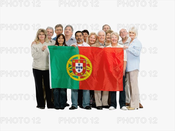 Group of people holding the Portuguese flag. Photo : momentimages