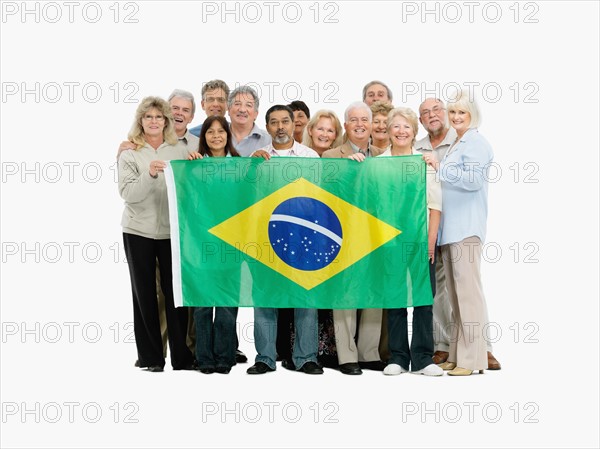 Group of people holding the Brazilian flag. Photo : momentimages