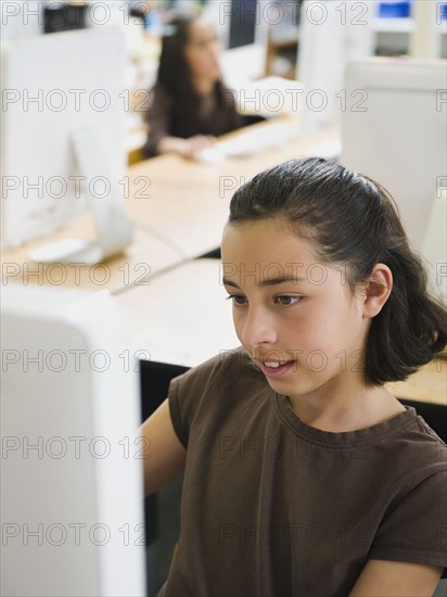 Students working on computers in classroom.