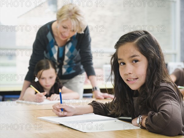 Elementary students writing in their notebooks.