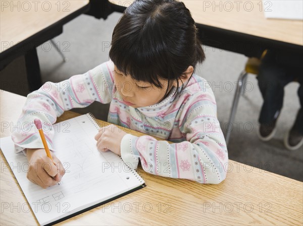 Elementary student writing in her notebook.