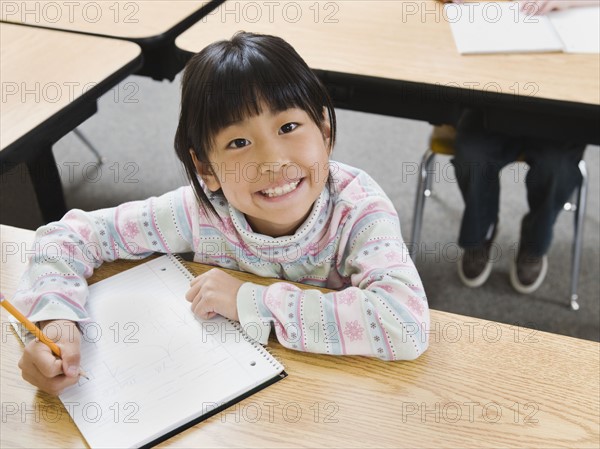 Elementary student writing in her notebook.