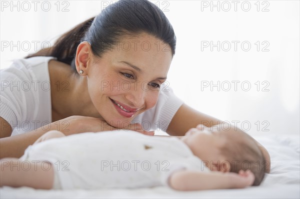 Mother watching her baby sleep.