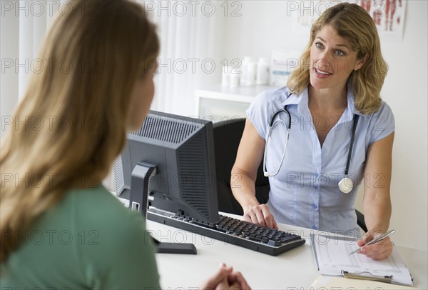 Medical consultation in exam room.