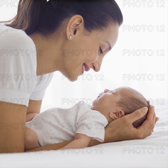 Mother holding her sleeping baby.