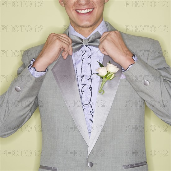 Man wearing grey tuxedo.