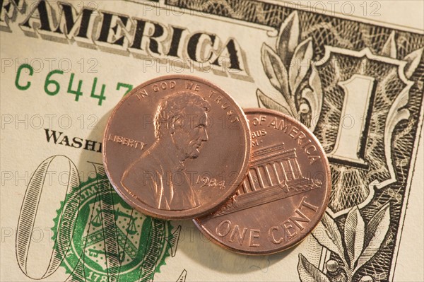 Pennies on top of American dollar bill.