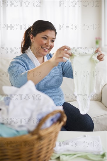 Overweight woman folding clothes.