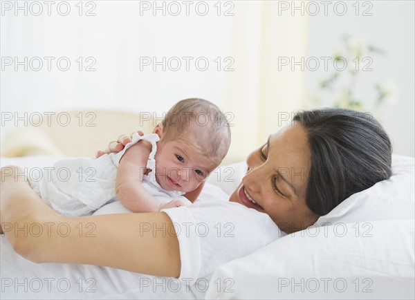 Mother lying down with her baby.