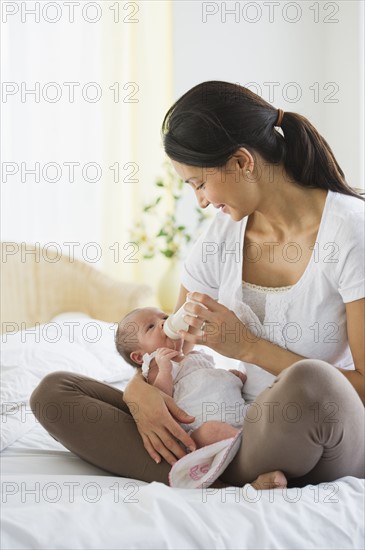 Mother feeding her baby a bottle.