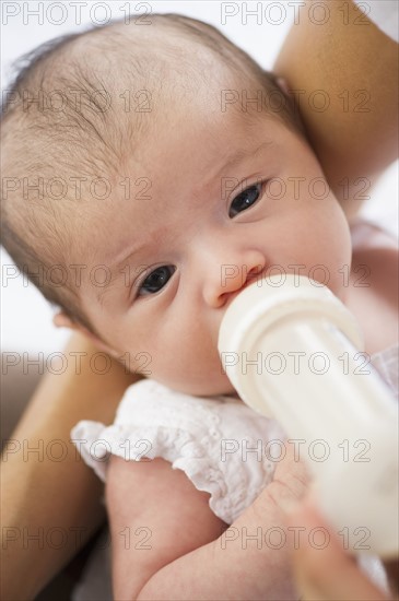 Mother feeding her baby a bottle.