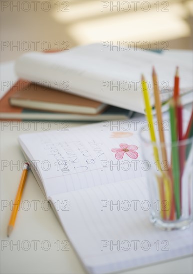 Child's notebook and colored pencils.