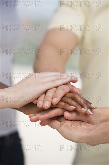 Hands atop one another.