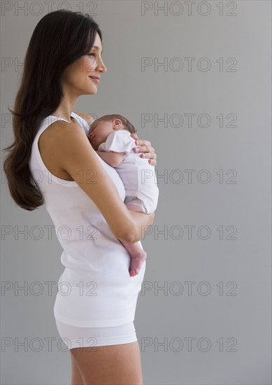 Woman holding her newborn baby.