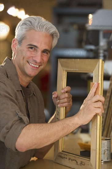 Craftsman making a picture frame.