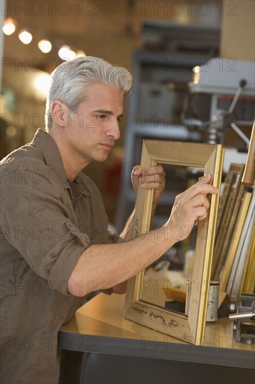 Craftsman making a picture frame.