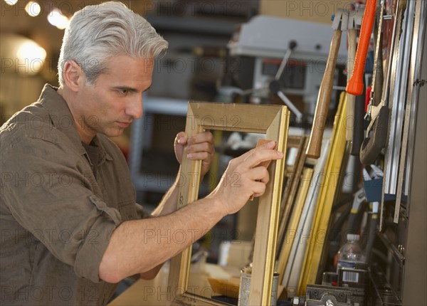 Craftsman making a picture frame.