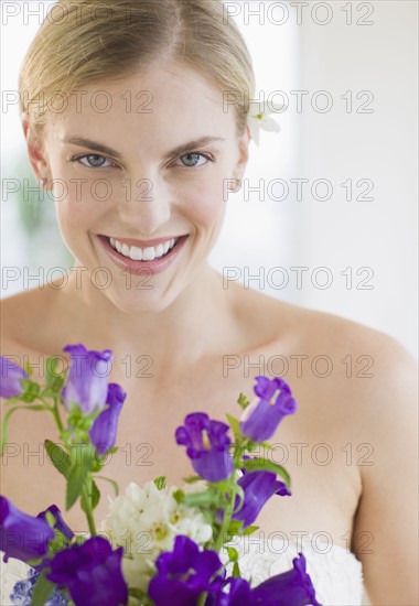 Bride holding bouquet of flowers.