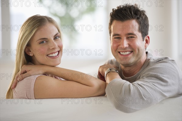 Happy couple relaxing on couch.