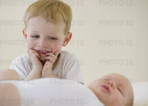 Brother watching his baby brother sleep. Photo : Chris Grill