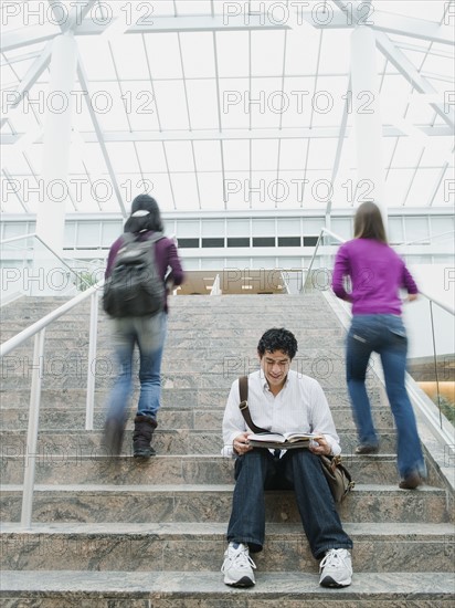 College students on steps in front of library.