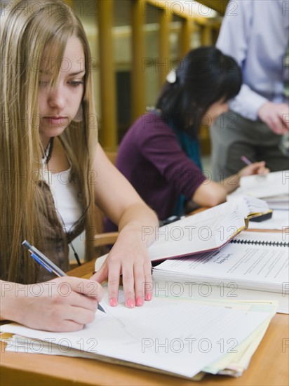 College students working in library.