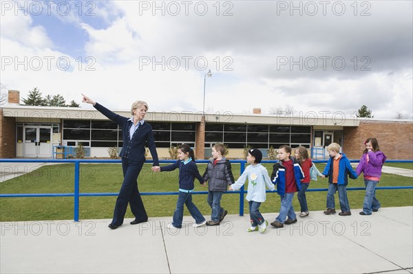 Elementary school students and teacher on a field trip.