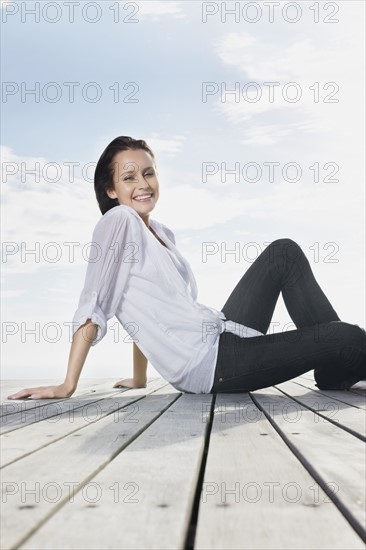 Woman relaxing on porch. Photo : momentimages