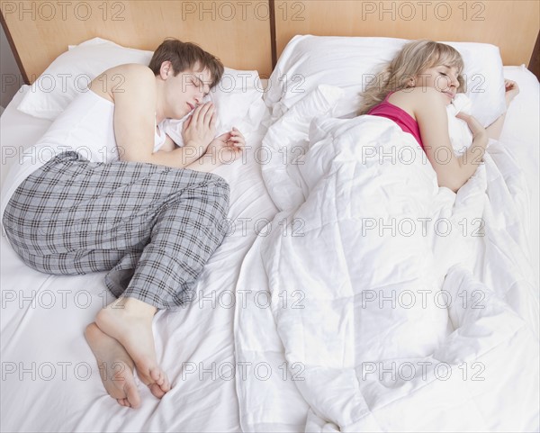 Couple sleeping in bed. Photo : Take A Pix Media