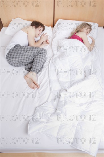 Couple sleeping in bed. Photo : Take A Pix Media