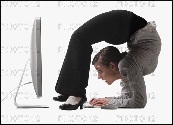 Businesswoman bending over backwards. Photo : Mike Kemp