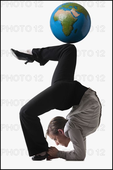 Businesswoman bending over backwards. Photo : Mike Kemp