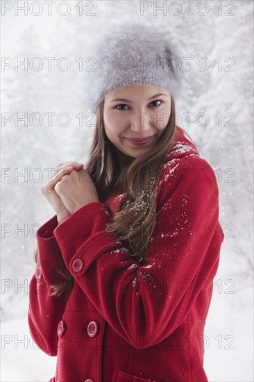 Woman wearing a red winter coat. Photo : Mike Kemp