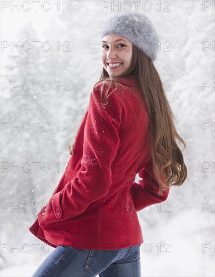 Happy woman outside on a snowy day. Photo : Mike Kemp