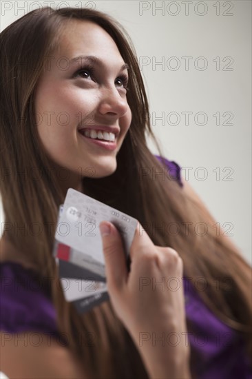 Smiling woman holding several credit cards. Photo : Mike Kemp