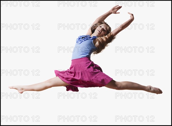 Female dancer jumping gracefully in the air. Photo : Mike Kemp