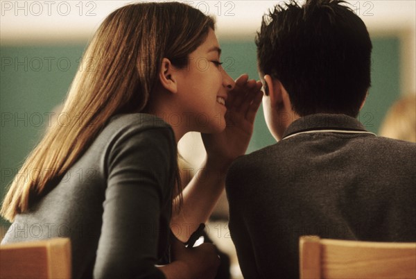 Students whispering in class. Photo : Rob Lewine