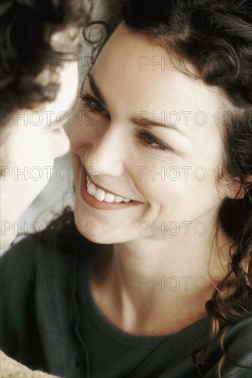 Woman gazing into man's eyes. Photo : Rob Lewine