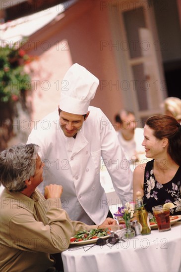 Chef talking to patron. Photo : Rob Lewine