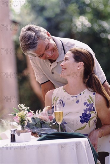 Happy couple having meal on patio. Photo : Rob Lewine