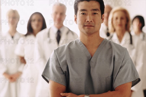 Doctor standing in front of medical team. Photo : Rob Lewine