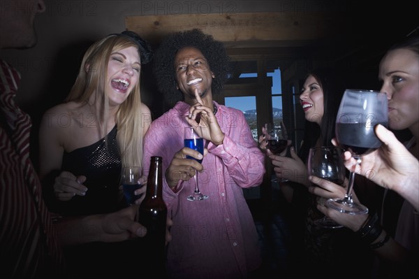 Group of people socializing at a party. Photo : Dan Bannister