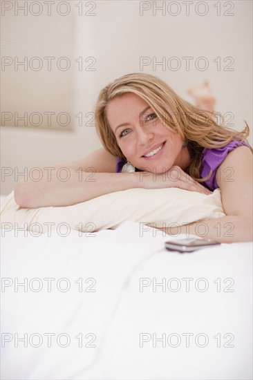Woman relaxing on bed. Photo : Dan Bannister