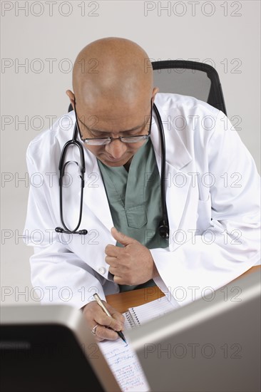 Doctor working at his desk. Photo : Dan Bannister