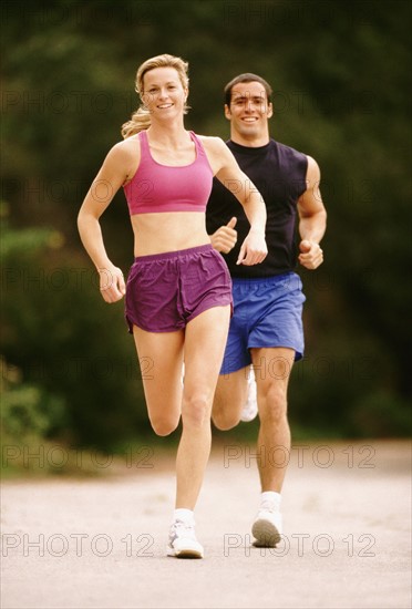 Couple jogging outdoors. Photo : Rob Lewine