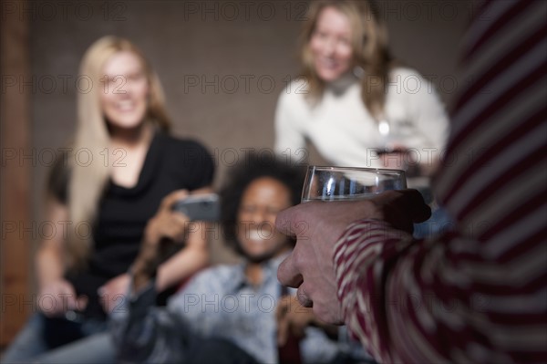 Group of people socializing at a party. Photo : Dan Bannister