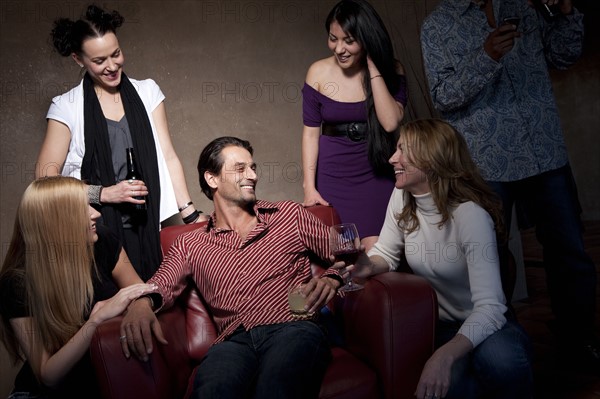 Group of people socializing at a party. Photo : Dan Bannister