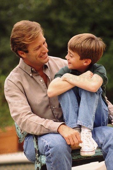 Father and son sitting outside together. Photo : Rob Lewine