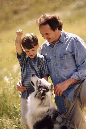 Father son and dog in field together. Photo : Rob Lewine